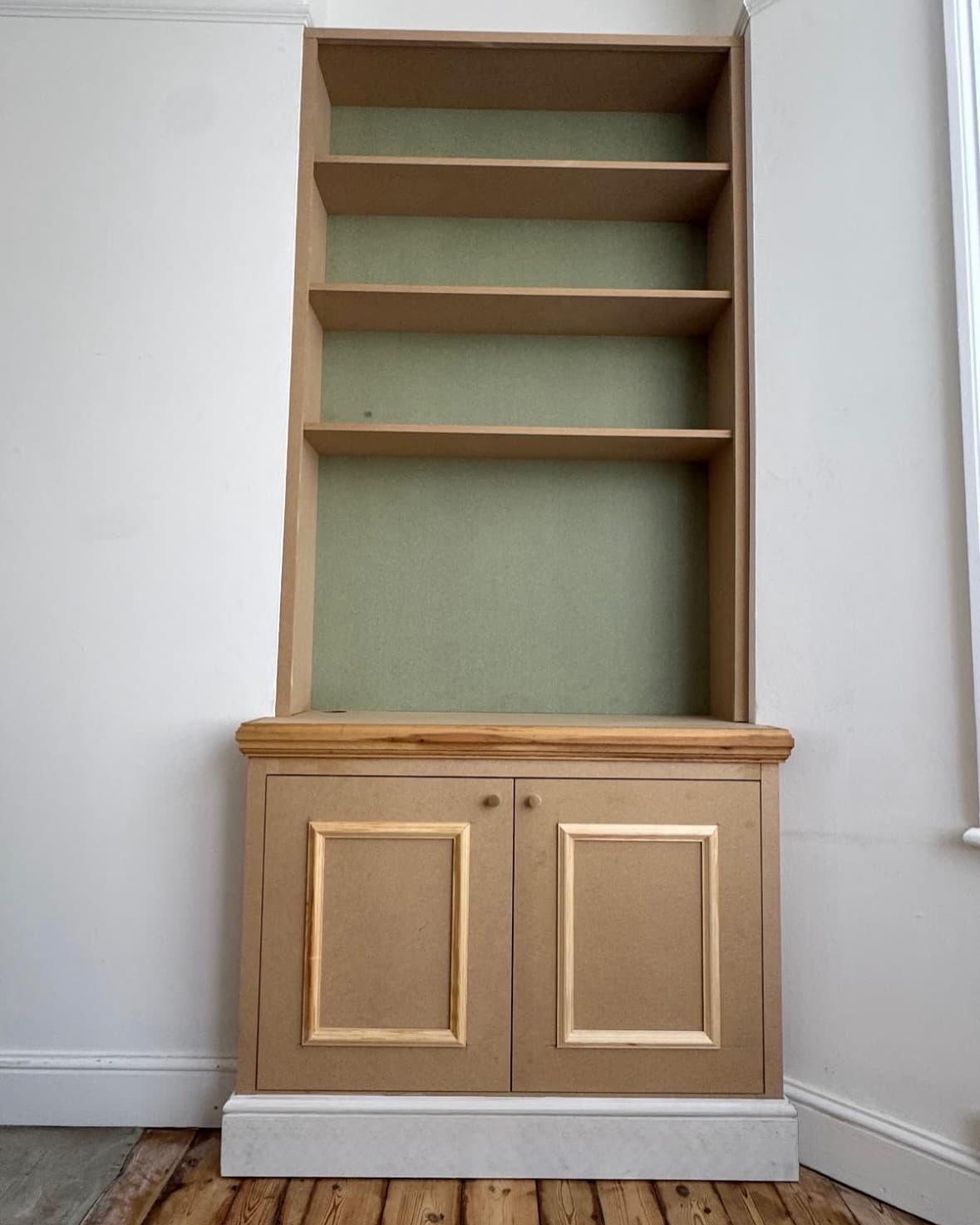 Bespoke alcove unit with shelving and room to house tv